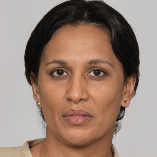 Joyful latino adult female with short  black hair and brown eyes