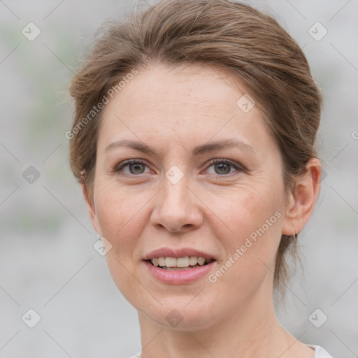 Joyful white adult female with short  brown hair and grey eyes