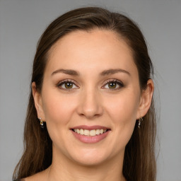 Joyful white young-adult female with long  brown hair and green eyes