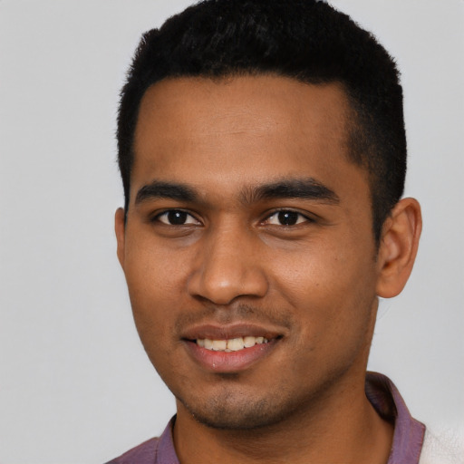 Joyful black young-adult male with short  black hair and brown eyes