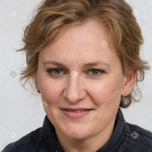 Joyful white adult female with medium  brown hair and blue eyes