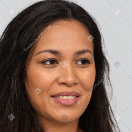 Joyful latino young-adult female with long  brown hair and brown eyes