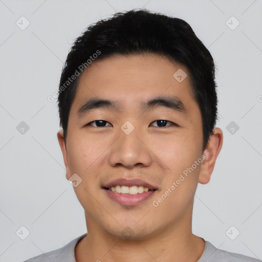 Joyful asian young-adult male with short  black hair and brown eyes