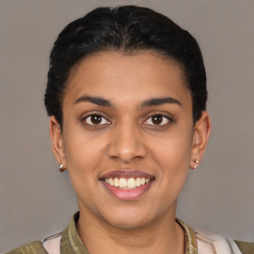 Joyful latino young-adult female with short  brown hair and brown eyes