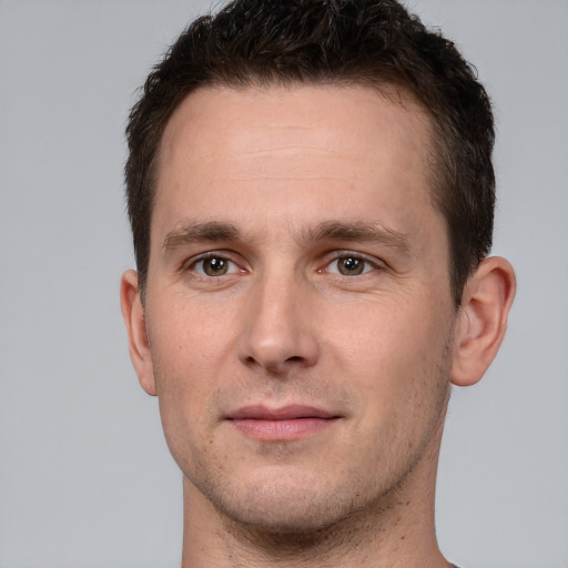 Joyful white young-adult male with short  brown hair and brown eyes