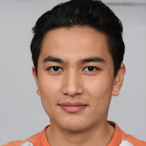 Joyful asian young-adult male with short  black hair and brown eyes