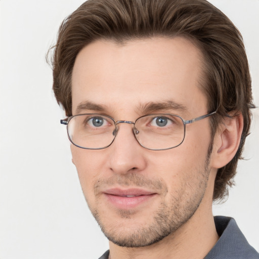 Joyful white adult male with short  brown hair and grey eyes