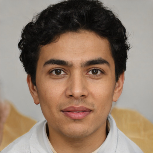 Joyful latino young-adult male with short  brown hair and brown eyes
