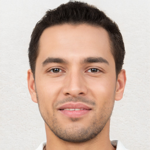 Joyful white young-adult male with short  brown hair and brown eyes