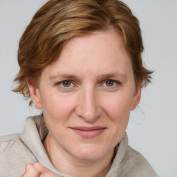 Joyful white adult female with medium  brown hair and blue eyes