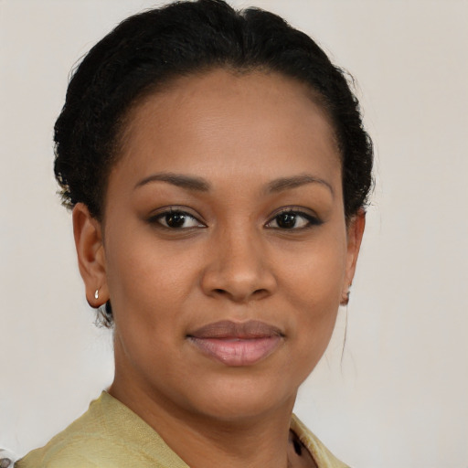 Joyful black young-adult female with short  brown hair and brown eyes