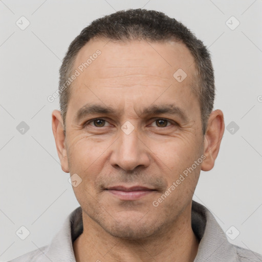 Joyful white adult male with short  black hair and brown eyes