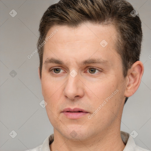 Joyful white adult male with short  brown hair and brown eyes