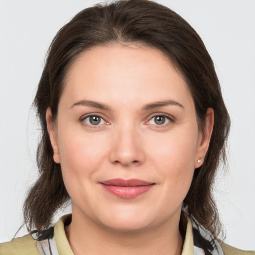 Joyful white young-adult female with medium  brown hair and brown eyes