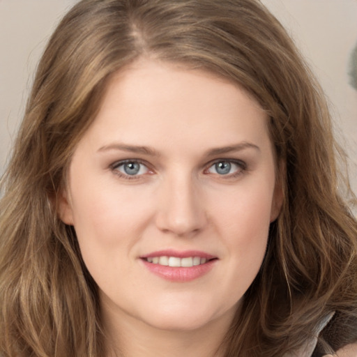 Joyful white young-adult female with long  brown hair and grey eyes