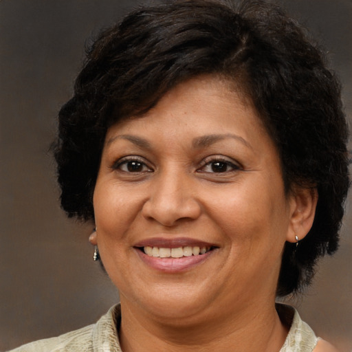Joyful latino adult female with short  brown hair and brown eyes