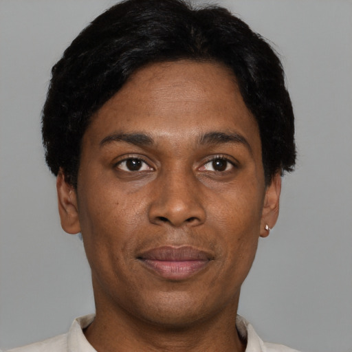 Joyful black adult male with short  black hair and brown eyes