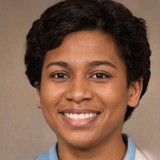 Joyful black young-adult female with short  brown hair and brown eyes