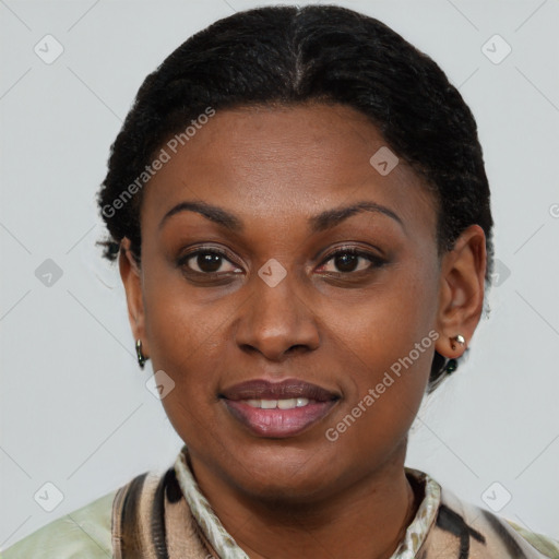 Joyful black young-adult female with short  black hair and brown eyes