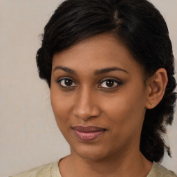 Joyful black young-adult female with medium  brown hair and brown eyes