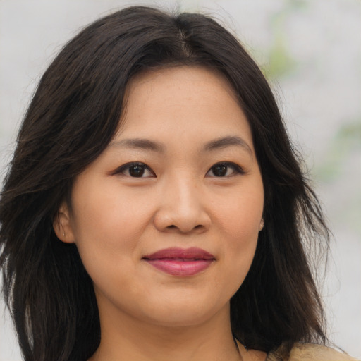 Joyful asian young-adult female with medium  brown hair and brown eyes