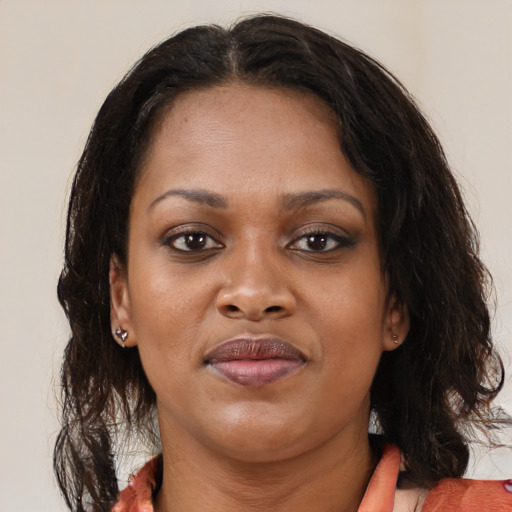 Joyful black young-adult female with medium  brown hair and brown eyes
