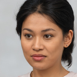 Joyful latino young-adult female with medium  brown hair and brown eyes