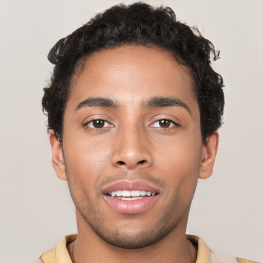 Joyful latino young-adult male with short  brown hair and brown eyes