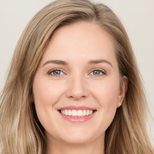 Joyful white young-adult female with long  brown hair and green eyes