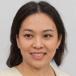 Joyful asian young-adult female with medium  brown hair and brown eyes