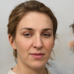 Joyful white adult female with medium  brown hair and brown eyes