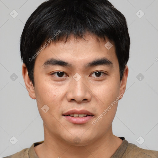 Joyful asian young-adult male with short  black hair and brown eyes