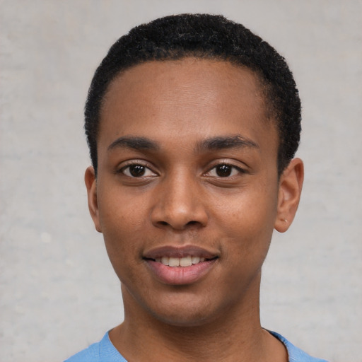 Joyful black young-adult male with short  black hair and brown eyes