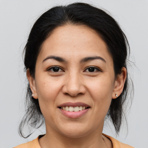 Joyful asian young-adult female with medium  brown hair and brown eyes