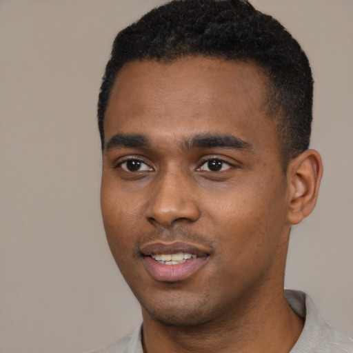 Joyful black young-adult male with short  black hair and brown eyes