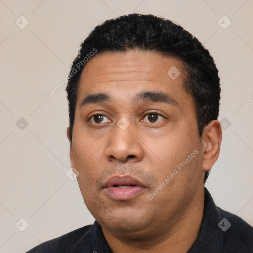 Neutral latino young-adult male with short  black hair and brown eyes