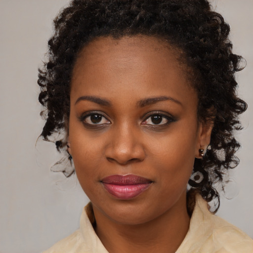 Joyful black young-adult female with medium  brown hair and brown eyes