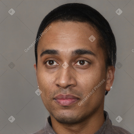 Joyful black young-adult male with short  black hair and brown eyes