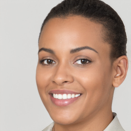 Joyful latino young-adult female with short  brown hair and brown eyes