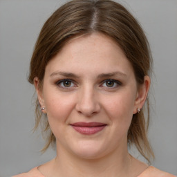 Joyful white young-adult female with medium  brown hair and grey eyes