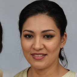 Joyful white young-adult female with medium  brown hair and brown eyes