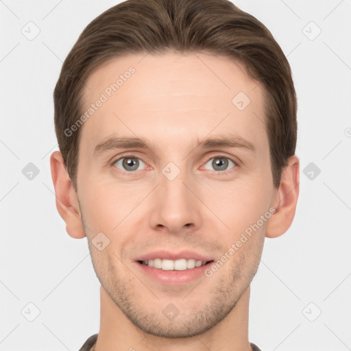 Joyful white young-adult male with short  brown hair and grey eyes