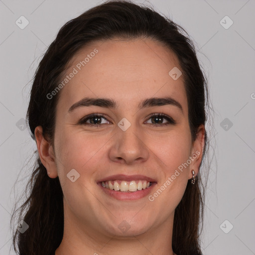 Joyful white young-adult female with long  brown hair and brown eyes