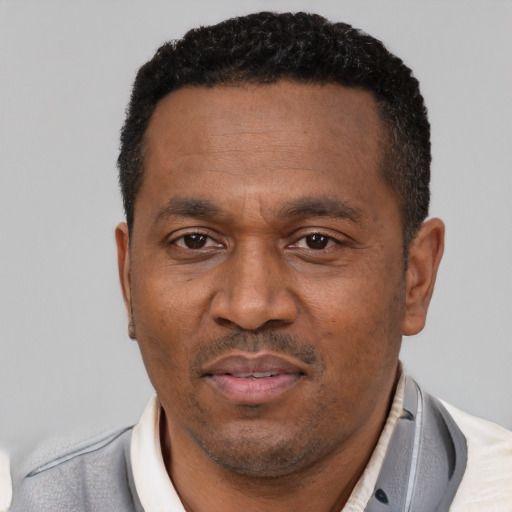 Neutral latino adult male with short  black hair and brown eyes