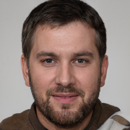 Joyful white adult male with short  brown hair and brown eyes