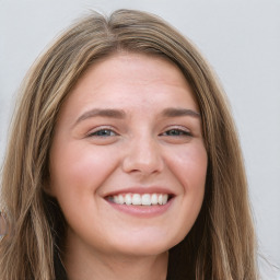 Joyful white young-adult female with long  brown hair and green eyes