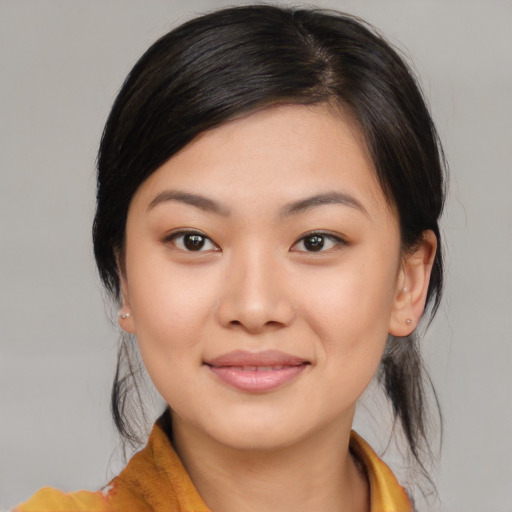 Joyful asian young-adult female with medium  brown hair and brown eyes