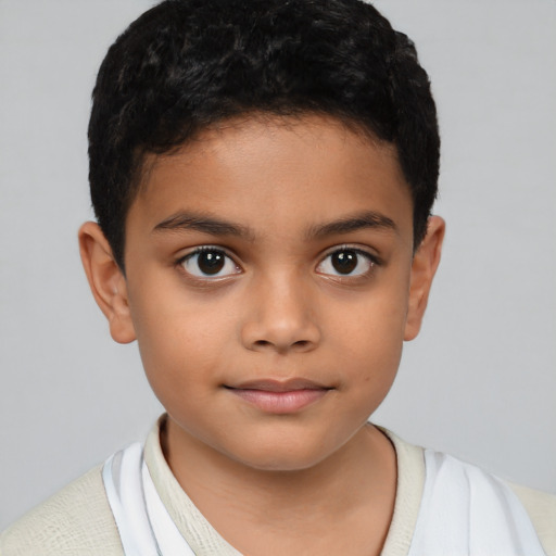 Joyful latino child male with short  brown hair and brown eyes