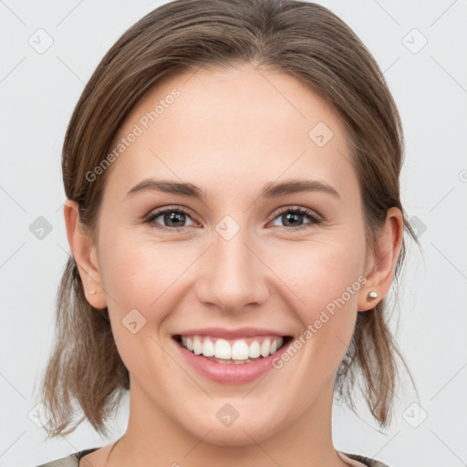 Joyful white young-adult female with medium  brown hair and grey eyes