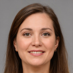 Joyful white young-adult female with long  brown hair and brown eyes